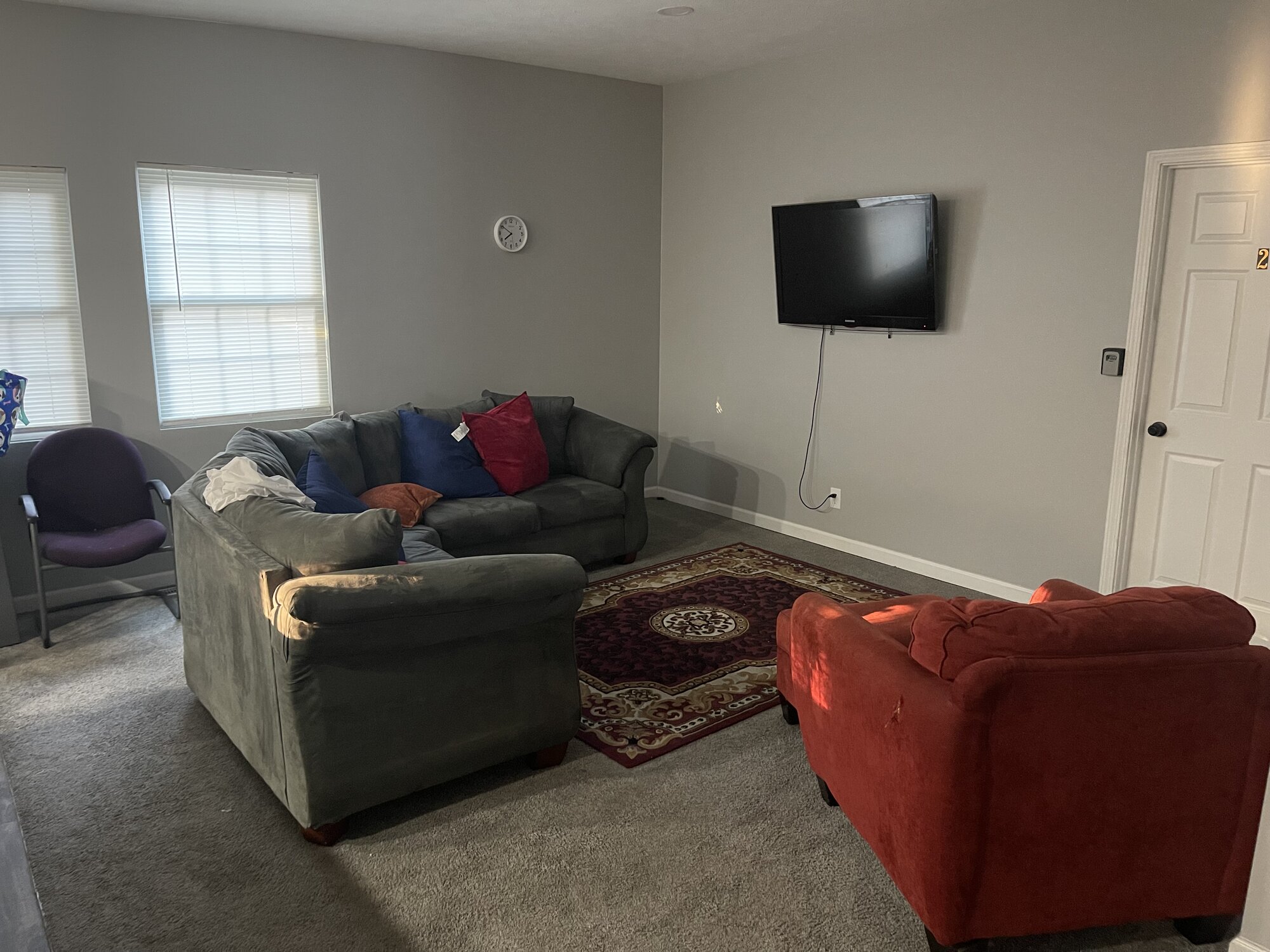 Living room with sofas and a wall-mounted TV