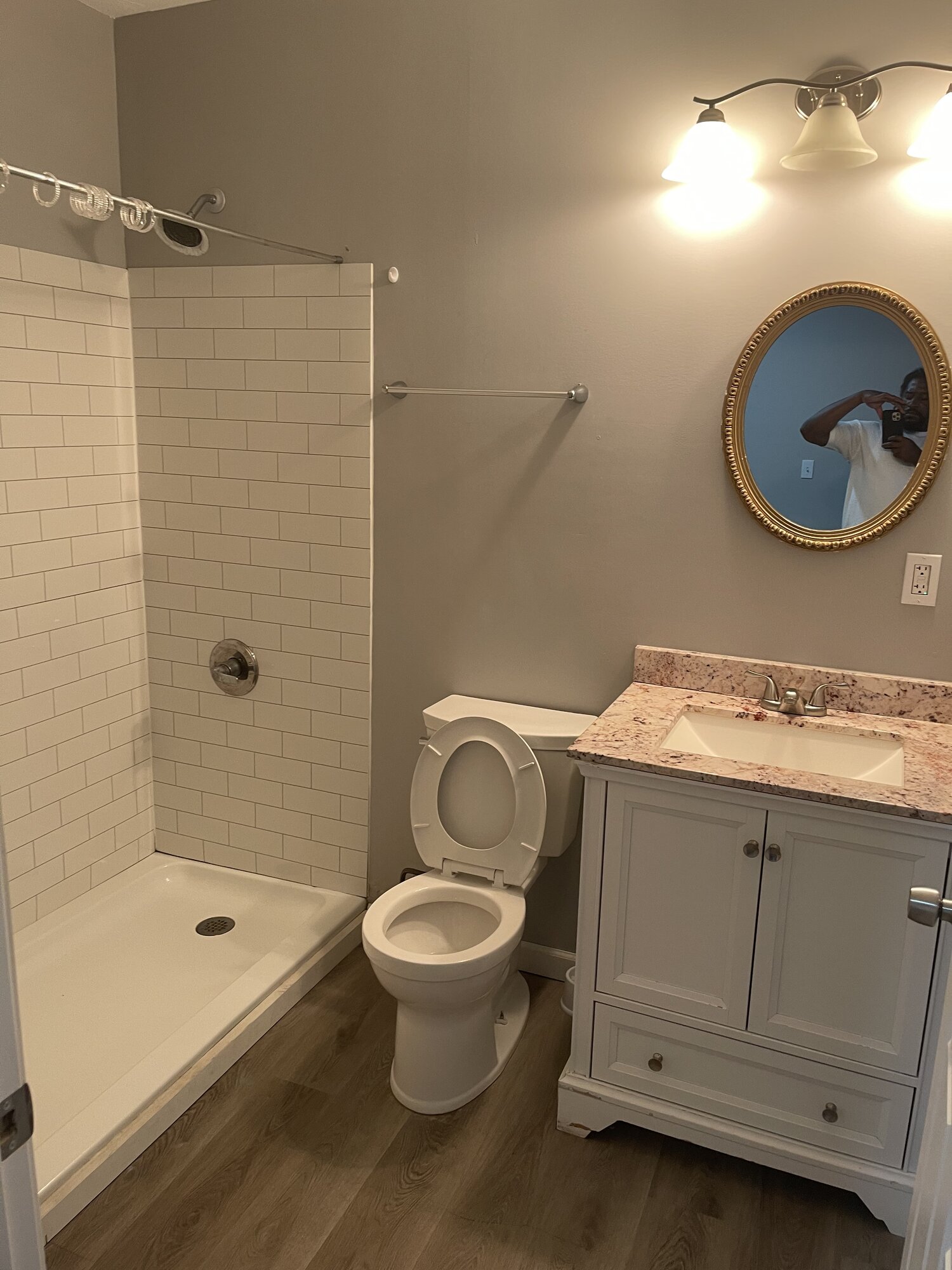 Bathroom with subway-tile shower and vanity