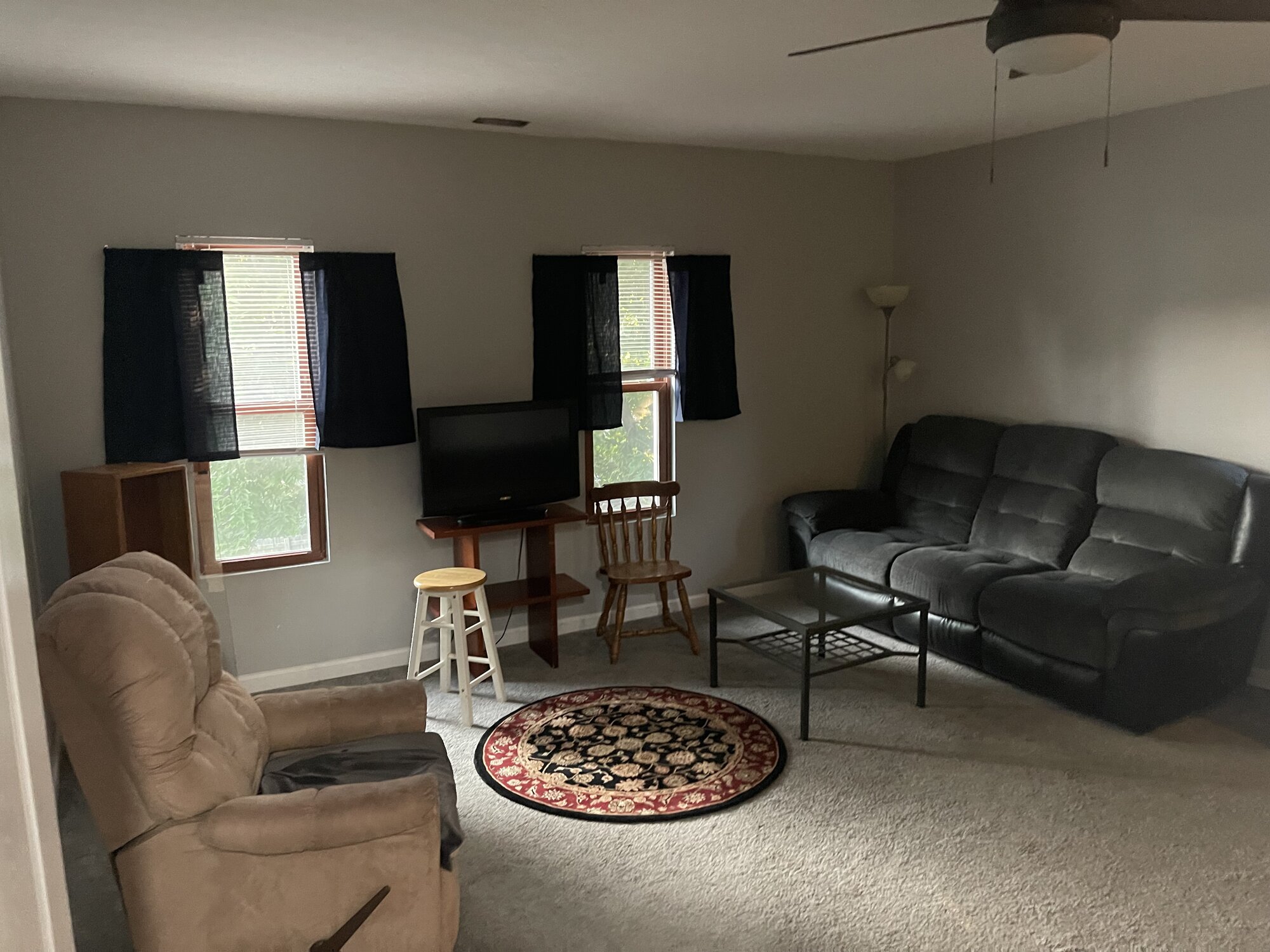 Lounge area with seating, TV, and natural light
