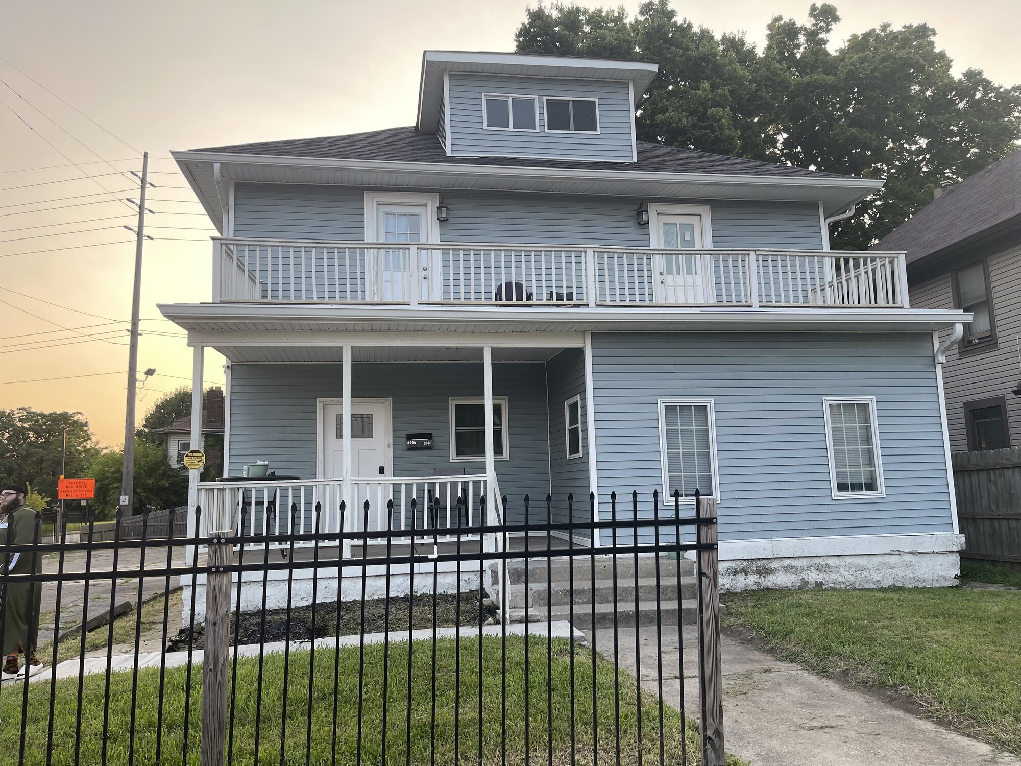 Hijrah House exterior — a blue two-story home with porch and balcony