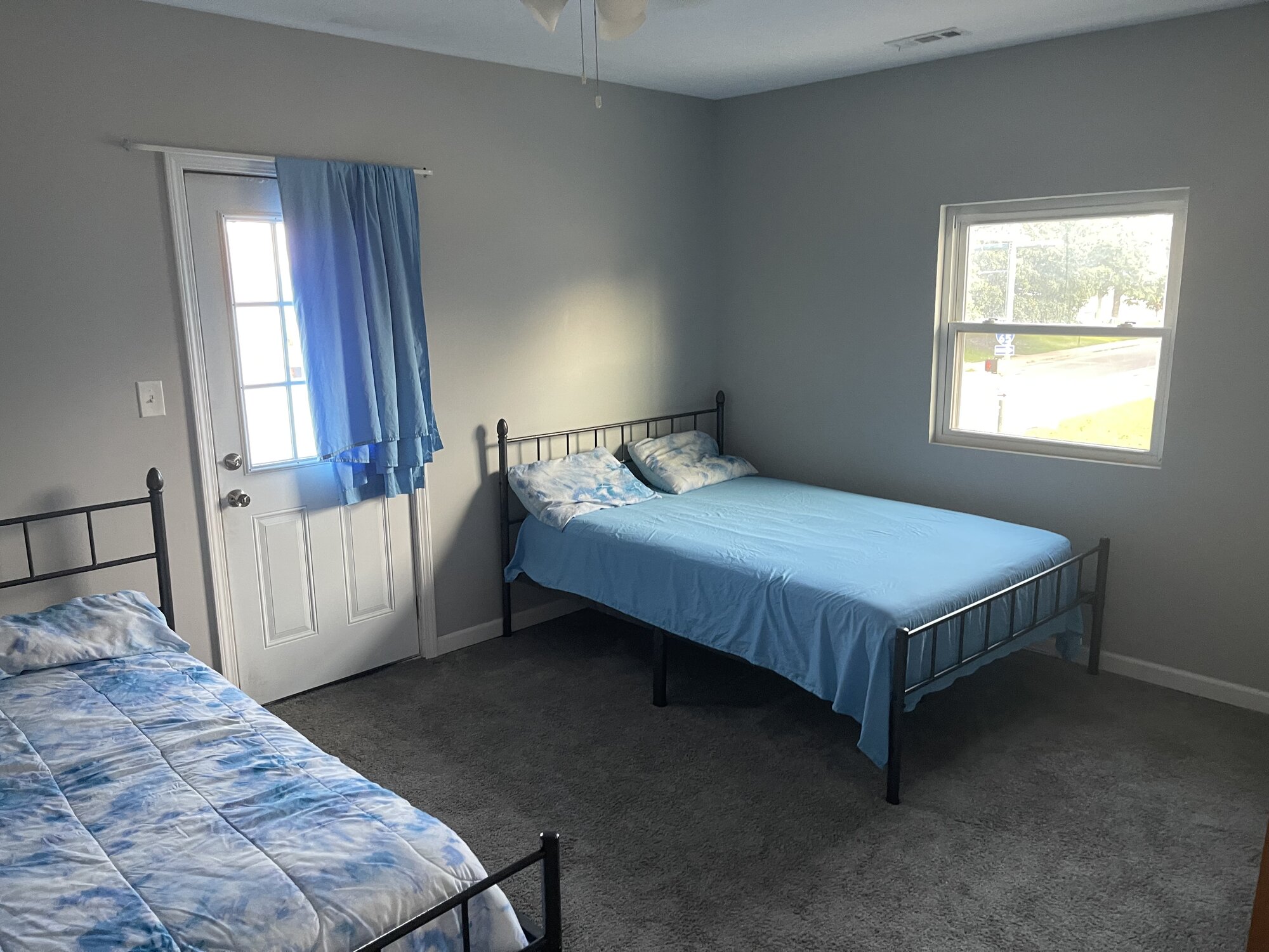 Shared bedroom with two beds and a window