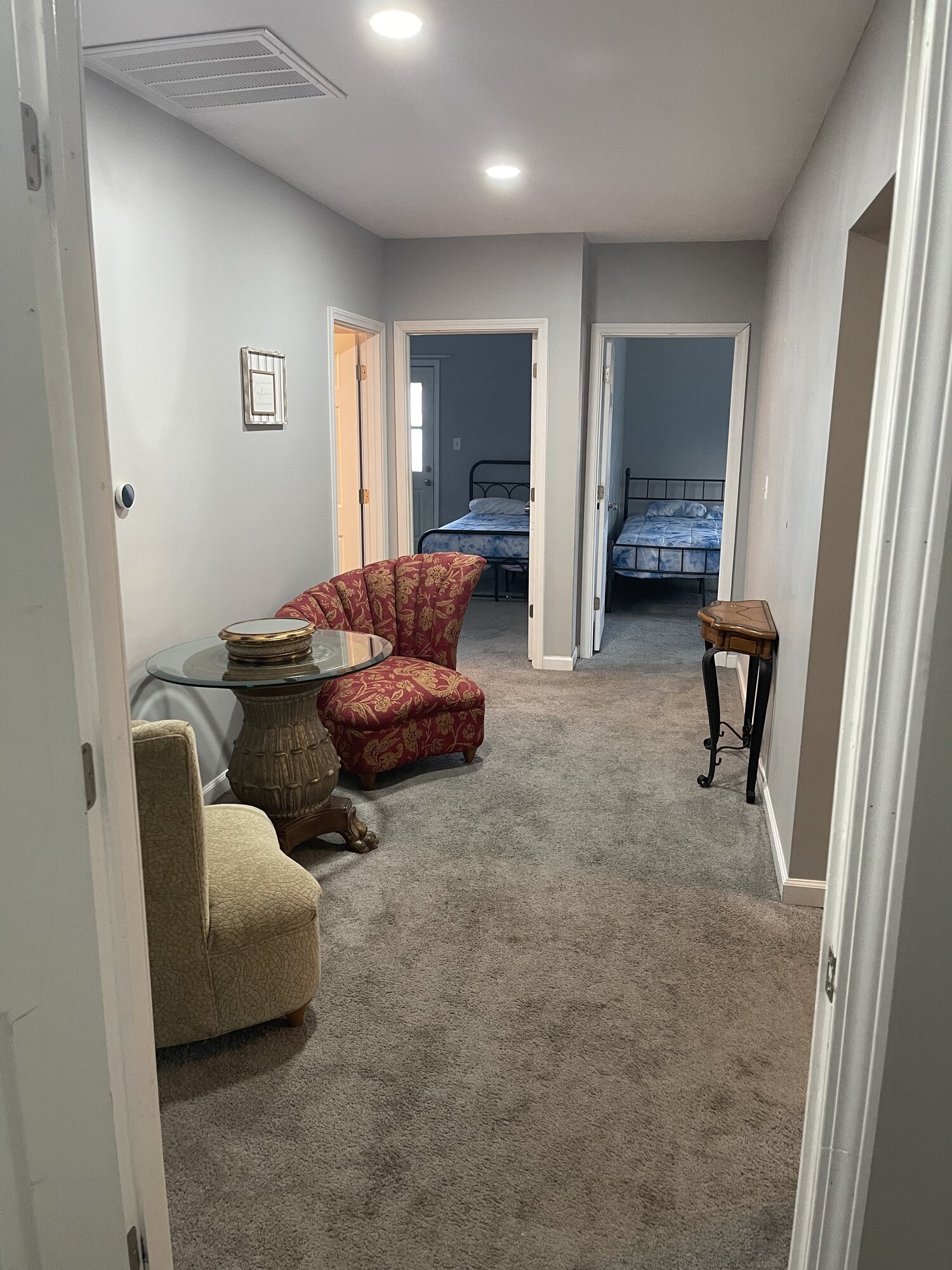 Hallway connecting bedrooms with seating area